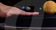 Miniature solar system orbits Sun lamp in the home