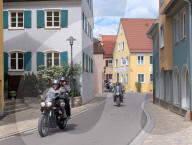 Motorcyclists Passing Through Residential Area