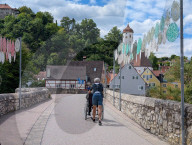 Two Seniors Crossing Bridge With Wheelchair