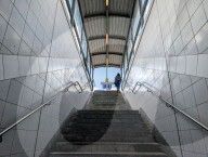Woman Ascending Train Station Stairway