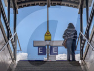 Woman Ascending Train Station Stairway