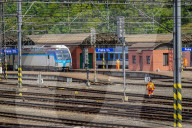 Track Labourer Crossing Rails At Station