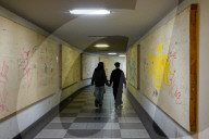 Young Couple Holding Hands In Underpass