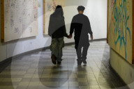 Young Couple Holding Hands In Underpass