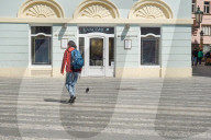 Pedestrian Walking Past Beauty Institute In Central Prague
