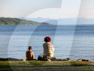 Couple Relaxing At Lake Starnberg Shore