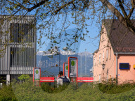 Tourists Waiting At Bus Stop In Garmisch-Partenkirchen