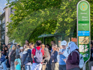 Tourists Waiting At Bus Stop In Garmisch-Partenkirchen