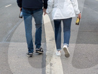 Couple Walking Hand In Hand With Beer Bottles