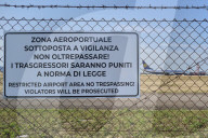 Restricted Area Warning At Bari Airport – Security Fence With Ryanair Aircraft In Background