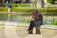 A Young Woman Absorbed In Her Smartphone