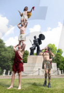 Australia's Head First Acrobats perform the feats of the ancient Greek Gods on the Archilles statue in Hyde Park, London, UK.