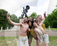 Australia's Head First Acrobats perform the feats of the ancient Greek Gods on the Archilles statue in Hyde Park, London, UK.