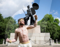 Australia's Head First Acrobats perform the feats of the ancient Greek Gods on the Archilles statue in Hyde Park, London, UK.