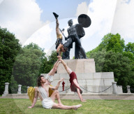 Australia's Head First Acrobats perform the feats of the ancient Greek Gods on the Archilles statue in Hyde Park, London, UK.