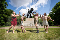 Australia's Head First Acrobats perform the feats of the ancient Greek Gods on the Archilles statue in Hyde Park, London, UK.