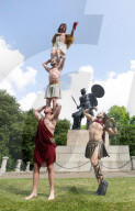 Australia's Head First Acrobats perform the feats of the ancient Greek Gods on the Archilles statue in Hyde Park, London, UK.
