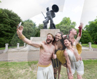 Australia's Head First Acrobats perform the feats of the ancient Greek Gods on the Archilles statue in Hyde Park, London, UK.