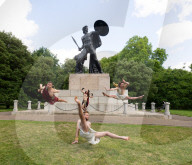 Australia's Head First Acrobats perform the feats of the ancient Greek Gods on the Archilles statue in Hyde Park, London, UK.