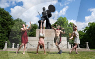 Australia's Head First Acrobats perform the feats of the ancient Greek Gods on the Archilles statue in Hyde Park, London, UK.