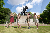 Australia's Head First Acrobats perform the feats of the ancient Greek Gods on the Archilles statue in Hyde Park, London, UK.