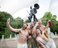 Australia's Head First Acrobats perform the feats of the ancient Greek Gods on the Archilles statue in Hyde Park, London, UK.