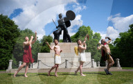 Australia's Head First Acrobats perform the feats of the ancient Greek Gods on the Archilles statue in Hyde Park, London, UK.
