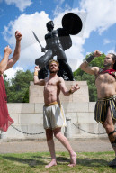 Australia's Head First Acrobats perform the feats of the ancient Greek Gods on the Archilles statue in Hyde Park, London, UK.