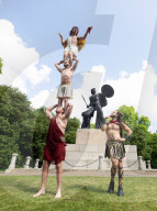 Australia's Head First Acrobats perform the feats of the ancient Greek Gods on the Archilles statue in Hyde Park, London, UK.