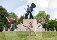 Australia's Head First Acrobats perform the feats of the ancient Greek Gods on the Archilles statue in Hyde Park, London, UK.