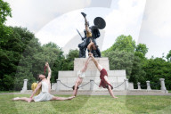 Australia's Head First Acrobats perform the feats of the ancient Greek Gods on the Archilles statue in Hyde Park, London, UK.