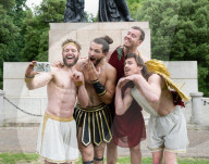 Australia's Head First Acrobats perform the feats of the ancient Greek Gods on the Archilles statue in Hyde Park, London, UK.