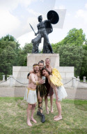 Australia's Head First Acrobats perform the feats of the ancient Greek Gods on the Archilles statue in Hyde Park, London, UK.