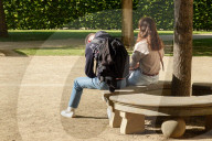 Couple In Tense Moment On Park Bench