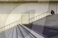 Young Man Sitting Alone On Staircase