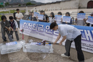 Activists Smash Ice To Protest Wage Freeze, Discrimination