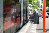 Woman Boards Tram With Stroller