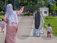 Women And Children Walking In Park On Sunny Day