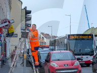 Municipal Workers Cleaning Traffic Lights In Vienna