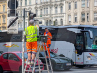 Municipal Workers Cleaning Traffic Lights In Vienna
