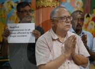 Buddhist Monks  And Devotees Offering Prayers In The Memory Of Victims Of Air India Plane Crash 