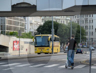 Two Young Men Riding One Scooter In Traffic