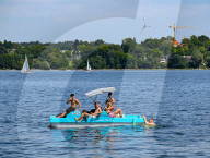 Group Of Young Men On Pedal Boat At Lake