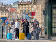 Tourists With Rolling Suitcases In Central Vienna