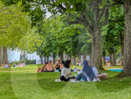 People Relaxing In Lakeside Park At Lake Starnberg
