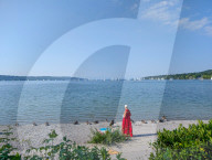 Senior Woman At The Shoreline Of Lake