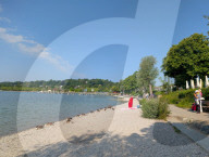 Senior Woman At The Shoreline Of Lake