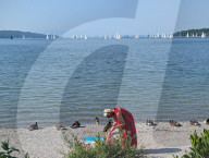 Senior Woman At The Shoreline Of Lake