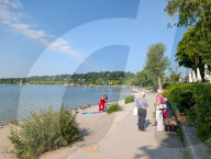 Senior Woman At The Shoreline Of Lake