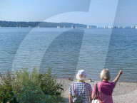 Senior Couple By The Lake In Summer